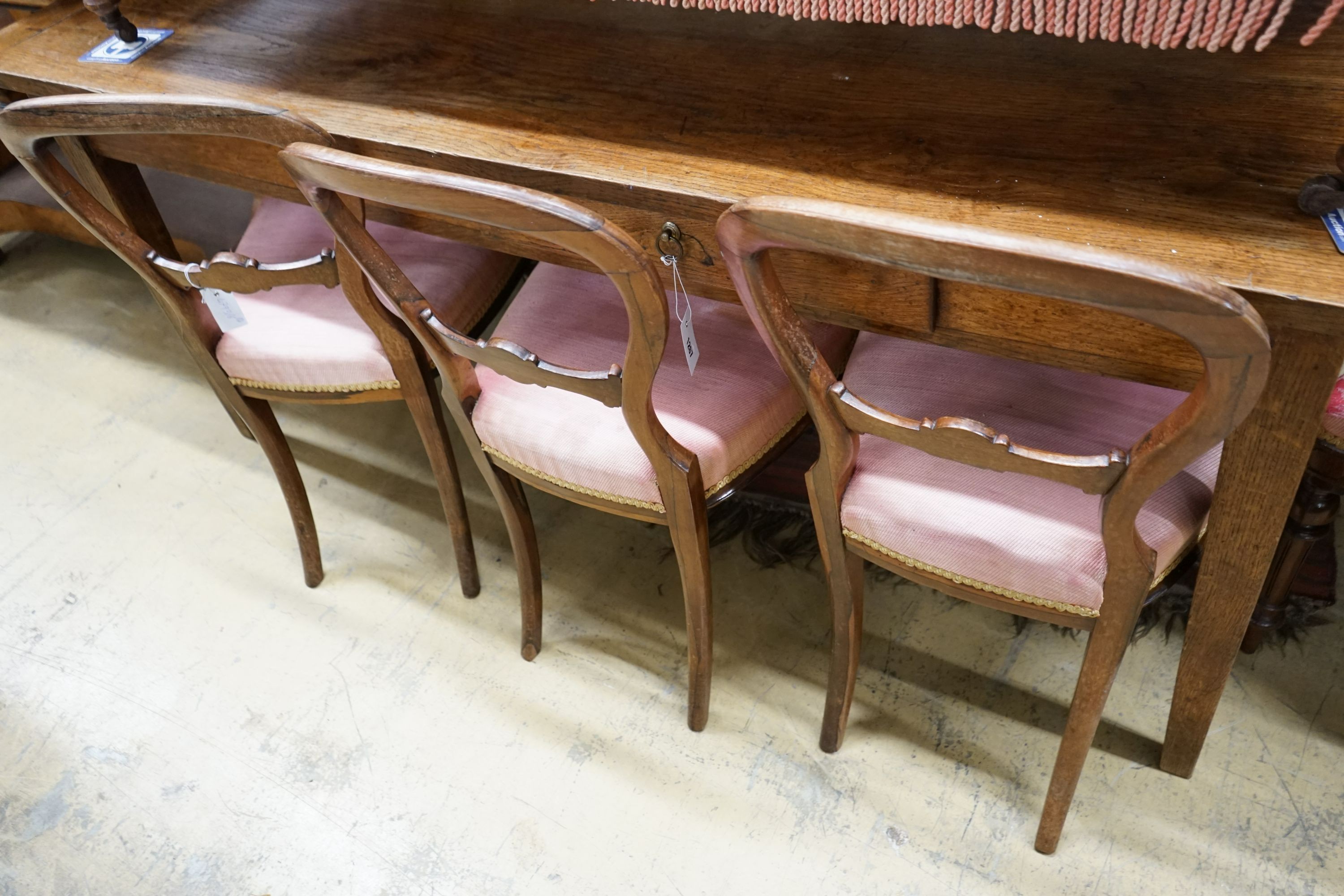 A set of four Victorian rosewood balloon back dining chairs